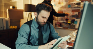 Man at a desk reviewing paperwork related to a bench warrant in Georgia